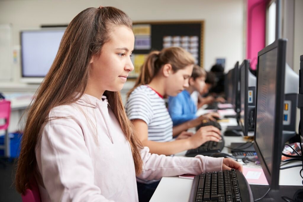 Students working at computers in a school classroom
